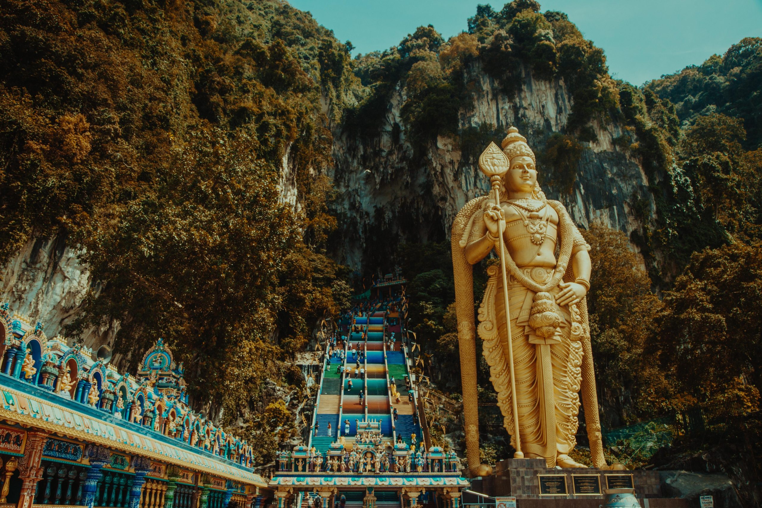 A short distance from the city centre, Batu Caves is a significant Hindu pilgrimage site featuring a series of stunning limestone caves. The colossal golden statue of Lord Murugan welcomes visitors at the entrance.