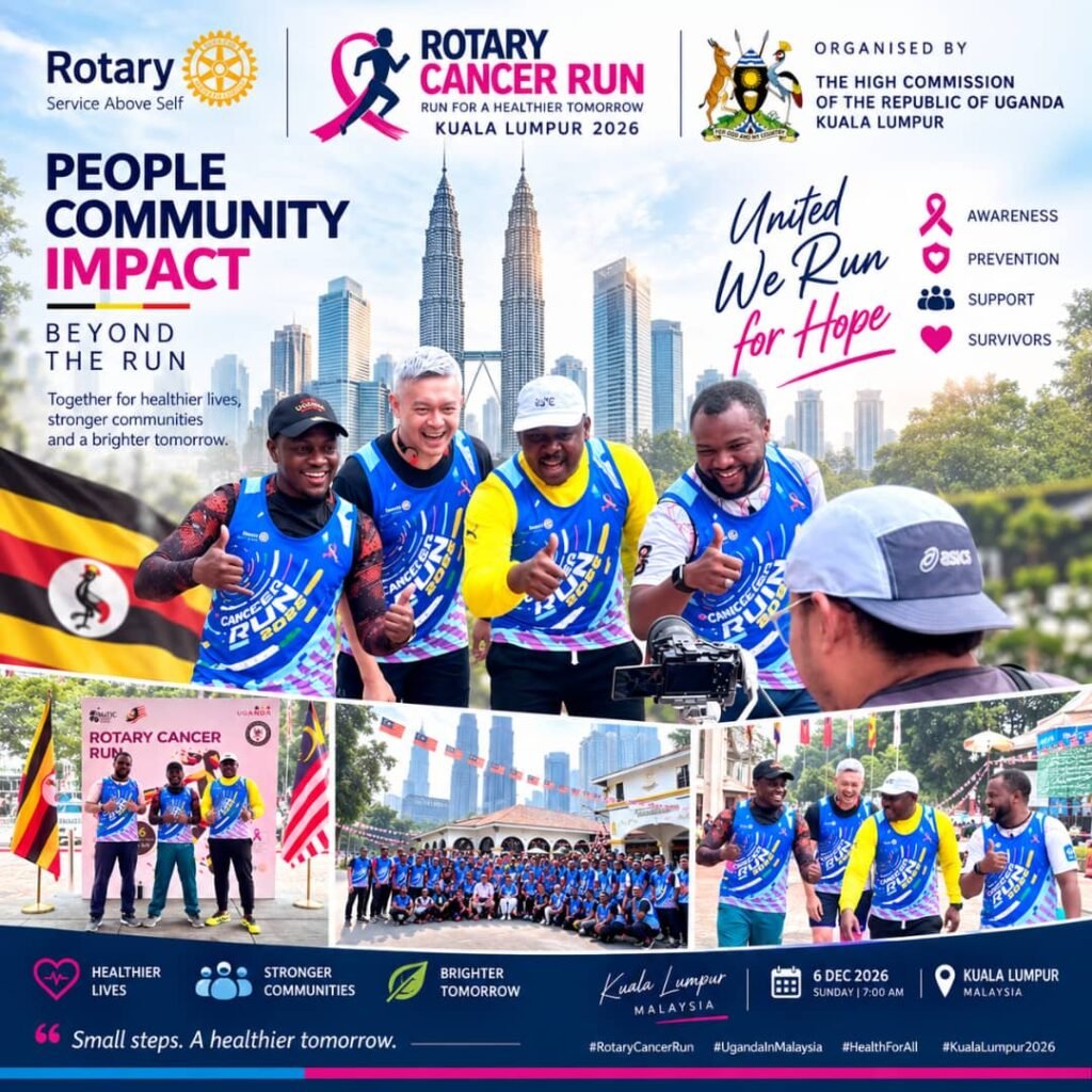 Members of the Ugandan community in Malaysia wearing Rotary Cancer Run vests, gathered together in front of the event backdrop in Kuala Lumpur