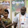 Uganda High Commission representatives and a UFZEPA exhibitor in conversation with a visitor at the Uganda stand at MIHAS 2026