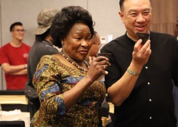 Two guests tasting Ugandan coffee from cupping cups