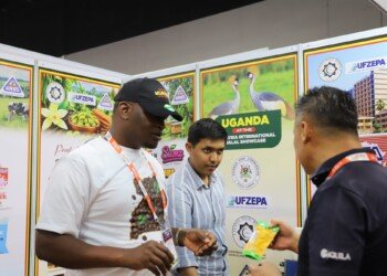 Ugandan exhibitors showing products to visitors at the Uganda pavilion