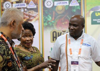 Uganda High Commission representatives and a UFZEPA exhibitor in conversation with a visitor at the Uganda stand at MIHAS 2026